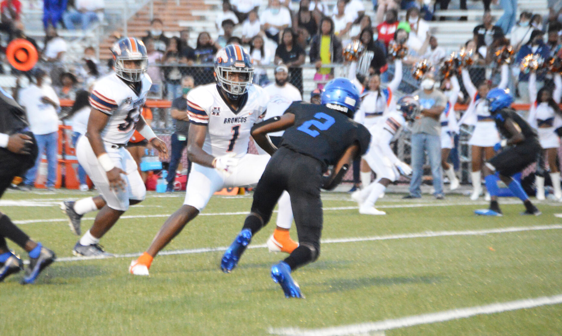 Bronco’s Dante Anderson (1) tries to hold the Buc’s X’zayvion Clayton (2).